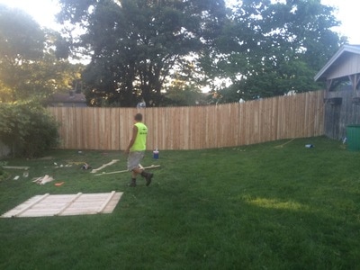 Building and installing custom wood fence around yard