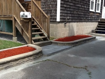 Two entry garden walls with fresh red mulch